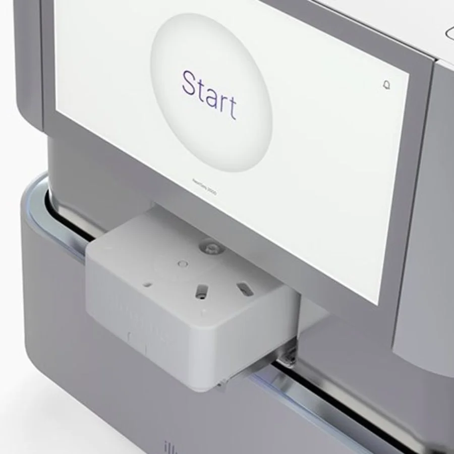 Medical diagnostic device screen with 'Start' button, white test cartridge inserted below.